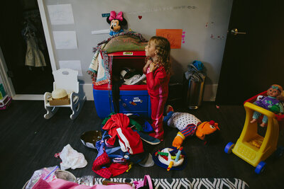 Small child in messy bedroom