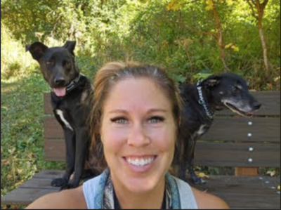Cornerstone Dog Trainer, Bri Green, sitting next to his German Shephard | Cornerstone Dog Training