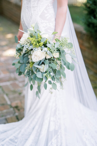 Soft elegant bridal bouquet with heavy silver dollar eucalyptus and light white flowers