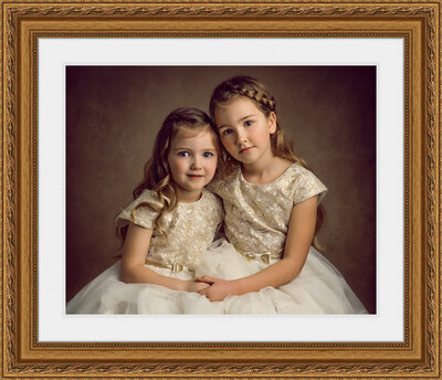 Gold framed print of a portrait of two young girls