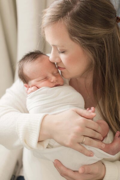 Hyde Park Cincinnati In-home newborn session mother holding baby closely