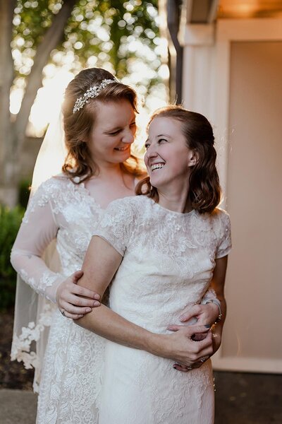 Two brides in lace wedding dresses on their wedding day