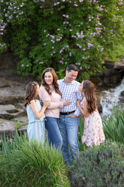 Family looking at each other smiling during photography session with Tiffany Hix in Boise