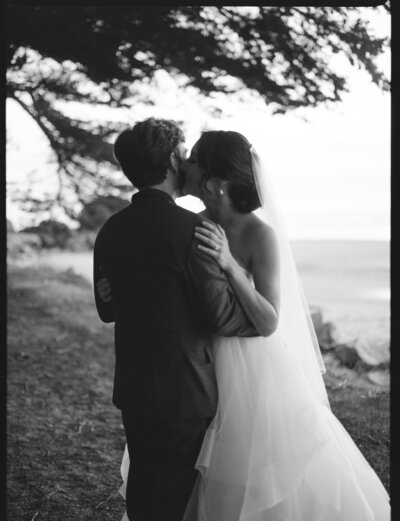 bride kissing grooms cheek at stinson beach