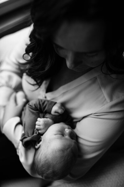 photo of mom holding newborn baby girl for photoshoot