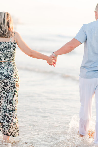 Couple on the beach holding hands by Miami lifestyle photographers David and Meivys of MSP Photography