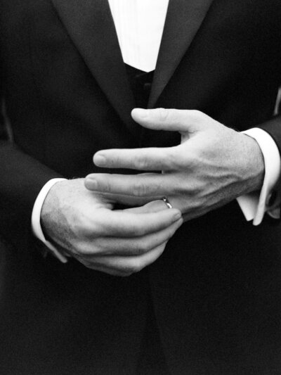 Groom plays with his wedding ring on his finger on his wedding day