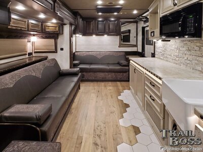 Couches and kitchen view inside a luxury horse trailer