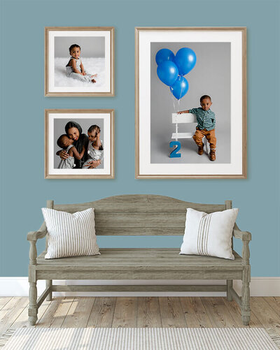 Framed photos of a family hanging in a home.