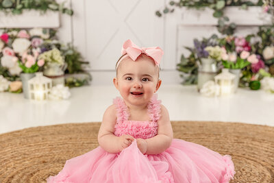baby sitting in pink dress by Philadelphia Newborn Photographer