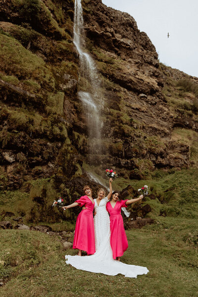 bride and bridesmaids beneath waterfall