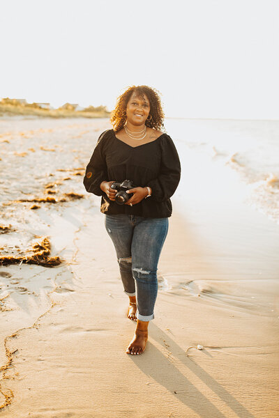 Black Female Photographer on the beach shore with her camera