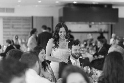 Bride and groom chatting with guests during reception at Downtown Market – West Michigan wedding photographer.