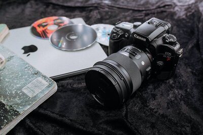 Professional Photography camera sitting with CDs