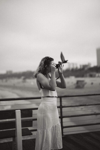 A portrait of Eilish using her film camera in America