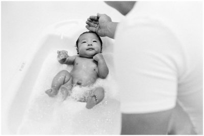 newborn getting bathed at home