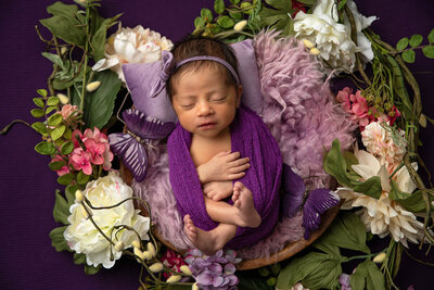 newborn wrapped in purple