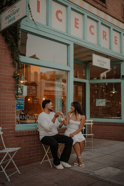 A couple shared an ice cream together for their engagement session photos in an urban setting
