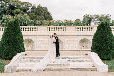 Couple standing facing each other at Rosecliff Mansion in Newport, Unique Melody Events & Design (New England Wedding Planners) helped