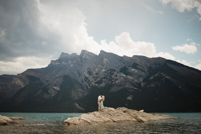 Stunning mountains captured by calgary wedding photographer, with newly wed bride and groom