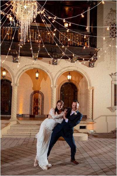 Candid moment during a first dance at the Powel Crosley Estate in Sarasota, FL, with string lights above.