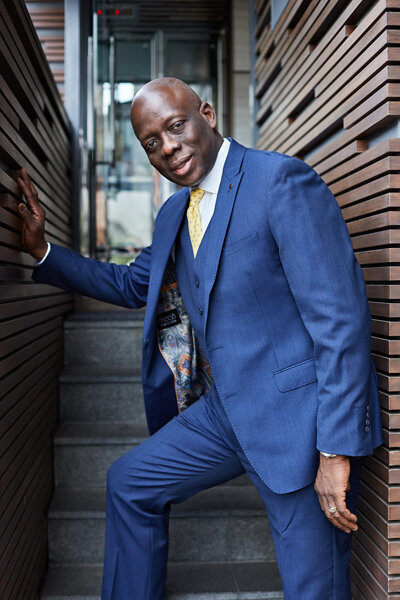 Portrait of Kingsley on a staircase to his office