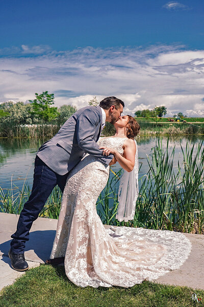 Bride and groom - kiss at the lake - photo by 4Karma Studio