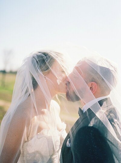Bride and groom kissing at Ashton Hill