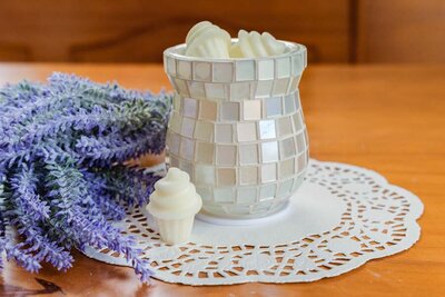 A wax melt holder surrounded by lavender with ice cream shaped wax melts