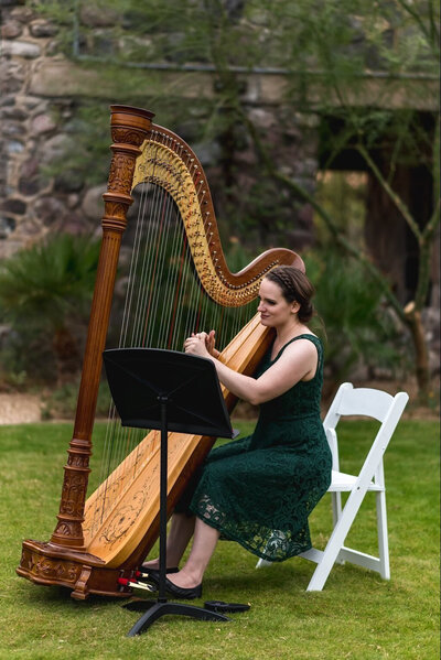 Wedding harpist in a green dress playing at Death Valley Oasis