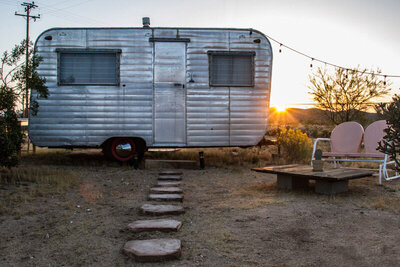 Destination branding photo mini airstream trailer in desert two lawn chairs beside it Gatos Trail Ranch