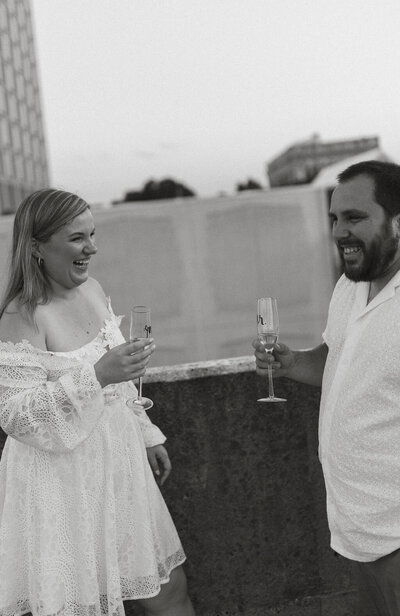 documentary engagement photos of a couple drinking champagne