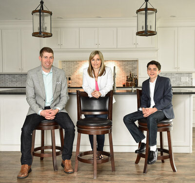 real estate investors sitting and standing in kitchen