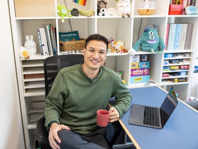 A-Baltimore-small-business-owner-smiles-during-his-brand-photoshoot-with-Ingrid-Berrios-in-his-therapist-office