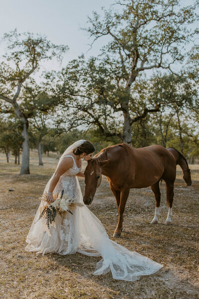 bride kisses horse for bridal session photos california