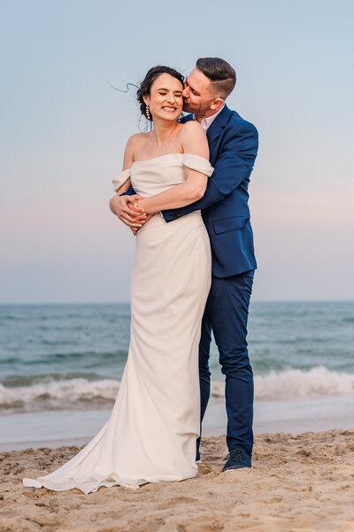 A newly married couple on their elopement on their elopement in Wrightsville Beach enjoying their Wilmington wedding photography
