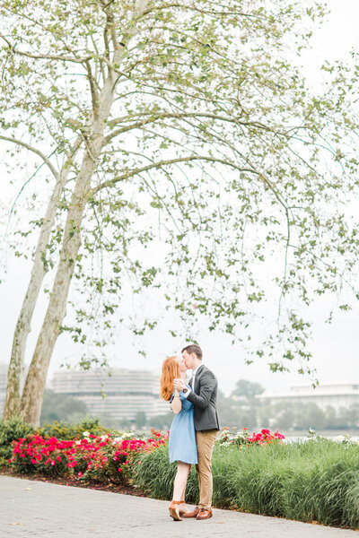 couple kiss under spring tree