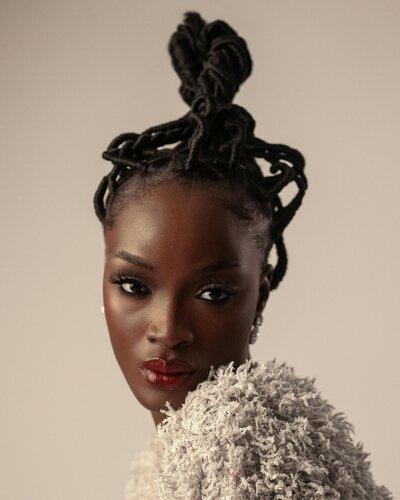 A Black woman wearing a fur top