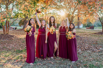 Five bridesmaids under fall foliage at The Hudson Manor by JoLynn Photography, a Raleigh wedding photographer