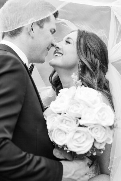bride and groom kissing at a vineyard