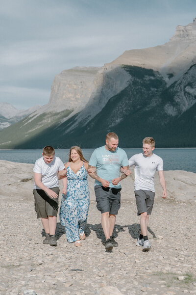 Man proposes to future wife on one knee at Moraine Lake in Banff National Park.