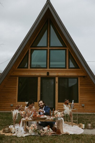 Bride and groom in front of A-frame airbnb during their North Carolina elopement.