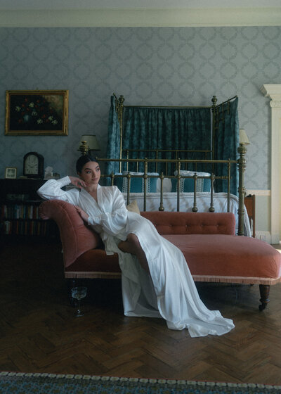 A modern bride capturing the essence of grace and beauty, posing with her bouquet in a breathtaking, serene environment