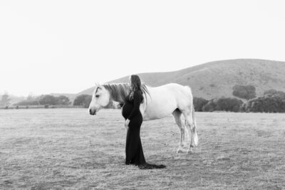 Salinas Valley Maternity photography with pregnant cowgirl and her horse in an open field.