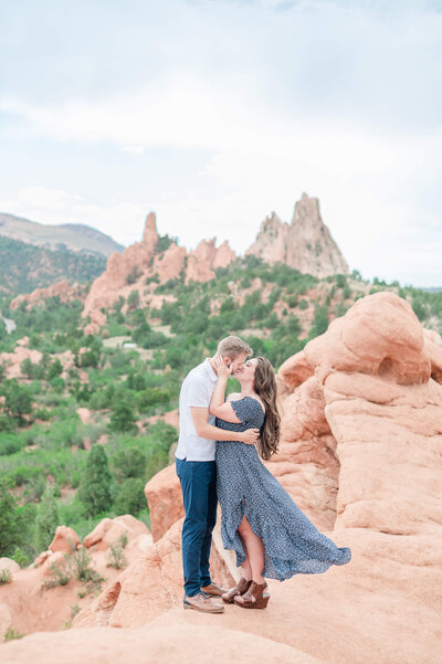 A couple embraces on the red rocks in Garden of the Gods park in Colorado Springs.