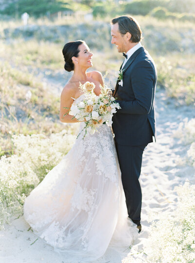 Bride and groom along the marsh on their wedding day at the Savannah Yacht Club