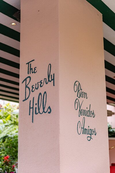 pink stucco entry reads The Beverly Hills