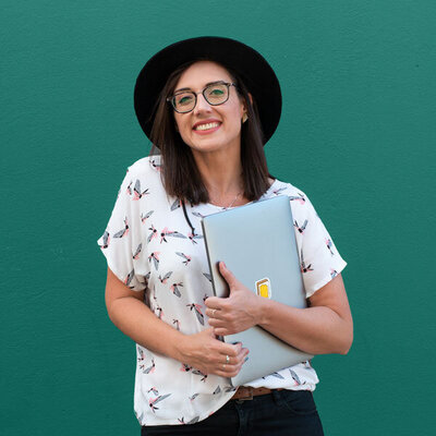 Photo of Marike holding laptop in hands and smilling