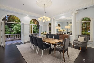 A real estate in Seattle featuring a dining room with arched windows and a chandelier.