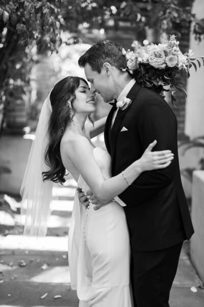 Bride and Groom embrace and smile as they are about to kiss at Royal Palms wedding venue